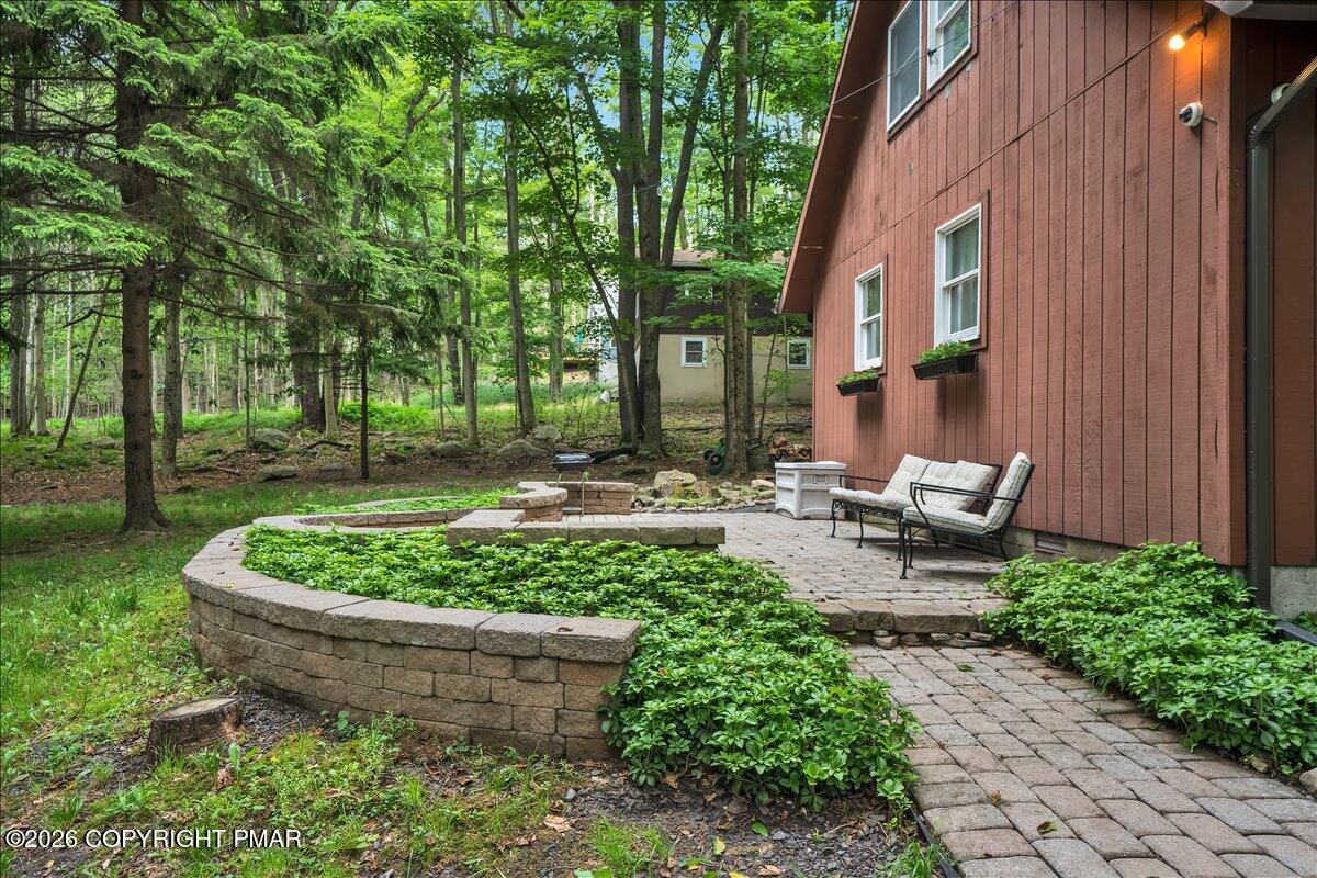 58 Sheffick Road, Unit E743 Gouldsboro, PA 18424 - Photo 25 of 44 a view of a backyard with plants and outdoor seating