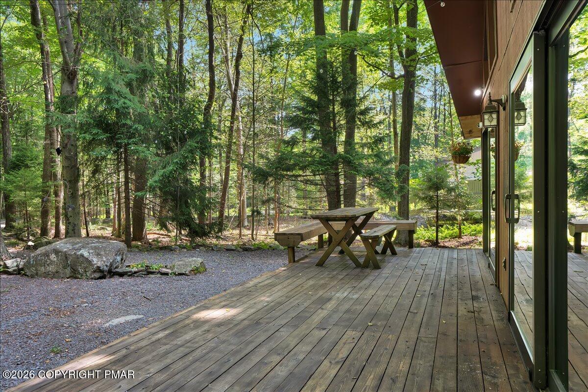 58 Sheffick Road, Unit E743 Gouldsboro, PA 18424 - Photo 33 of 44 a view of a patio with table and chairs and wooden floor