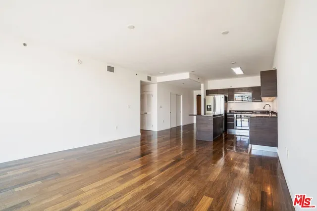 a view of a kitchen with cabinets and wooden floor