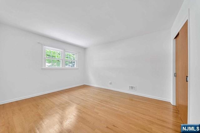 516 Knickerbocker Road Cresskill, NJ 07626 - Photo 18 of 31 an empty room with wooden floor and windows