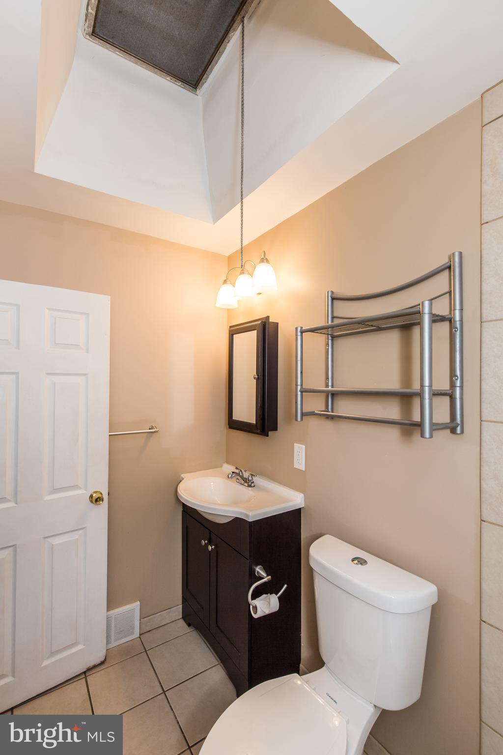 2757 East Country Club Road, Unit 2 Philadelphia, PA 19131 - Photo 13 of 24 a bathroom with a toilet sink and mirror