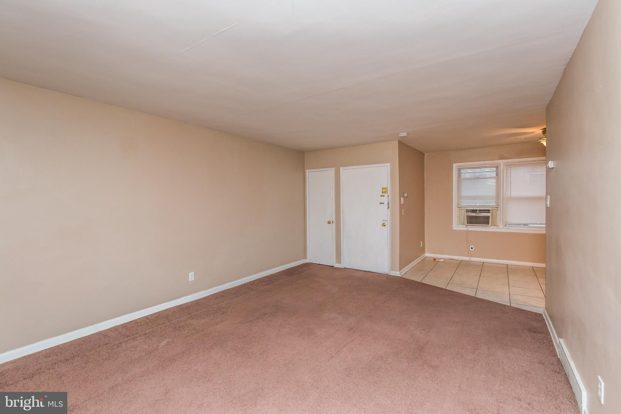 2757 East Country Club Road, Unit 2 Philadelphia, PA 19131 - Photo 3 of 24 wooden floor in an empty room with a window