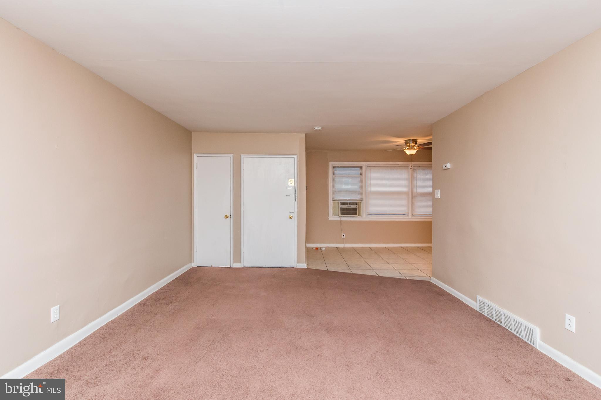 2757 East Country Club Road, Unit 2 Philadelphia, PA 19131 - Photo 4 of 24 a view of a big room with wooden floor and windows