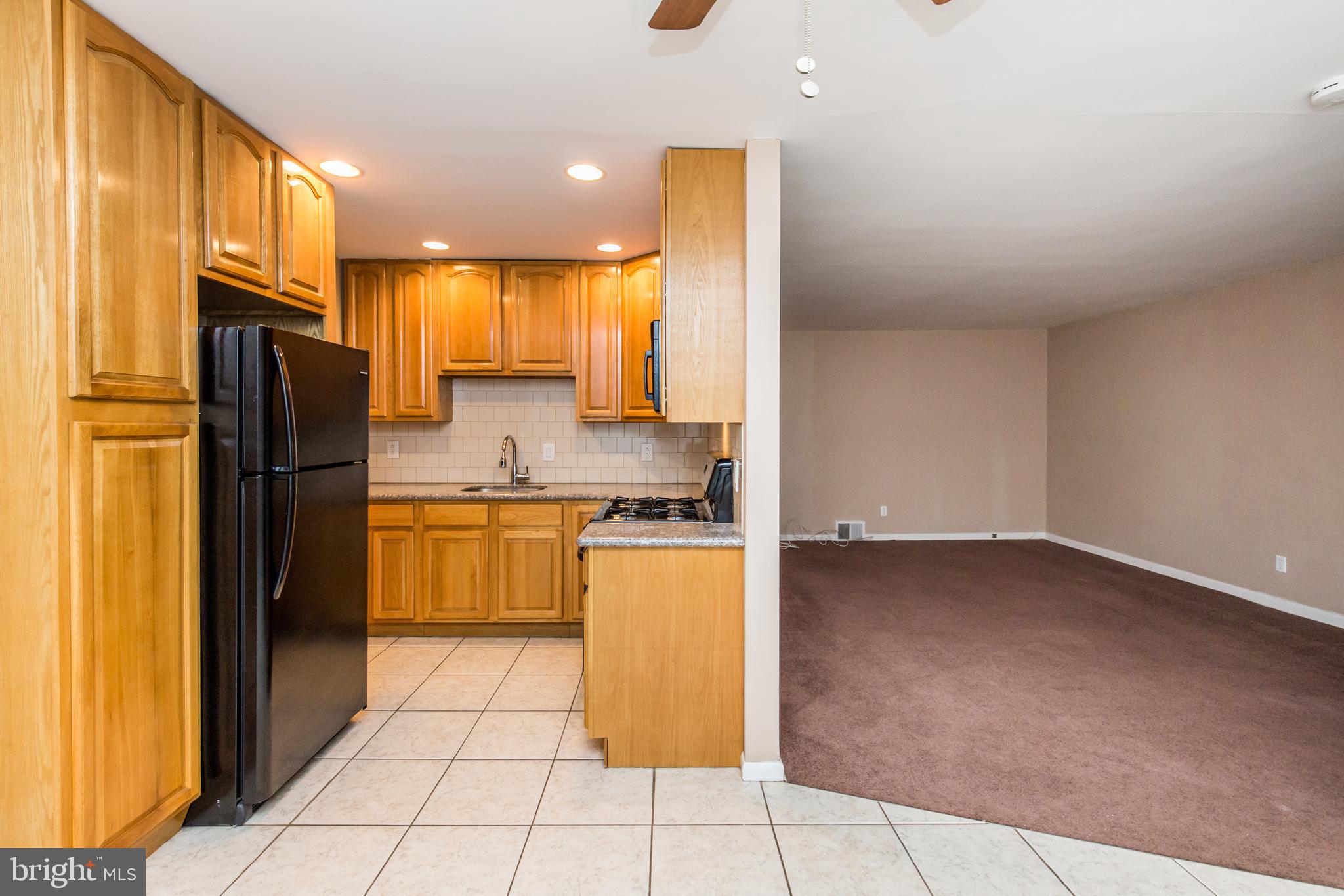 2757 East Country Club Road, Unit 2 Philadelphia, PA 19131 - Photo 7 of 24 a kitchen with a refrigerator a sink and cabinets