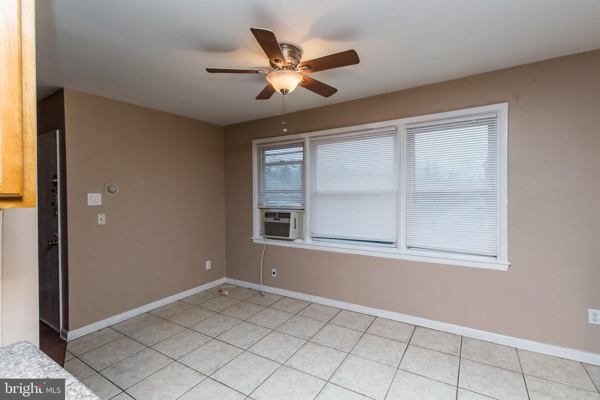 2757 East Country Club Road, Unit 2 Philadelphia, PA 19131 - Photo 10 of 24 an empty room with ceiling fan and windows