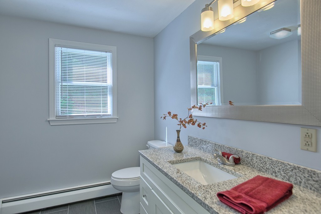 13 Valley Road Groton, MA 01450 - Photo 12 of 30 a bathroom with a granite countertop toilet sink and mirror