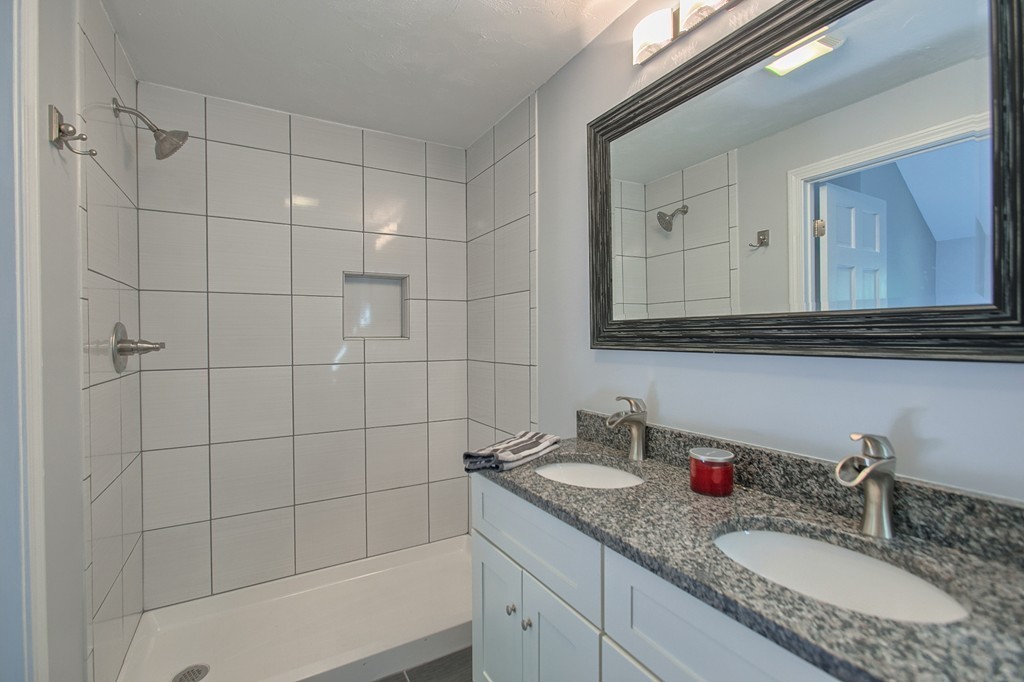 13 Valley Road Groton, MA 01450 - Photo 14 of 30 a bathroom with a granite countertop sink a mirror and shower