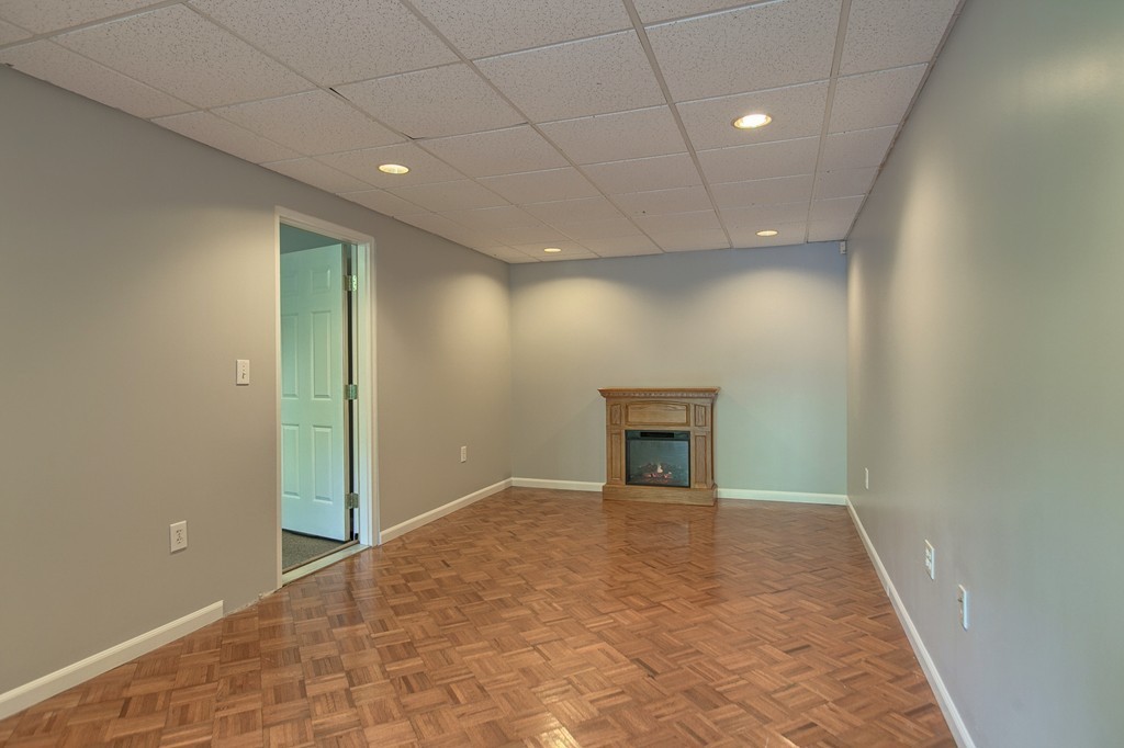 13 Valley Road Groton, MA 01450 - Photo 21 of 30 wooden floor in an empty room with a fireplace