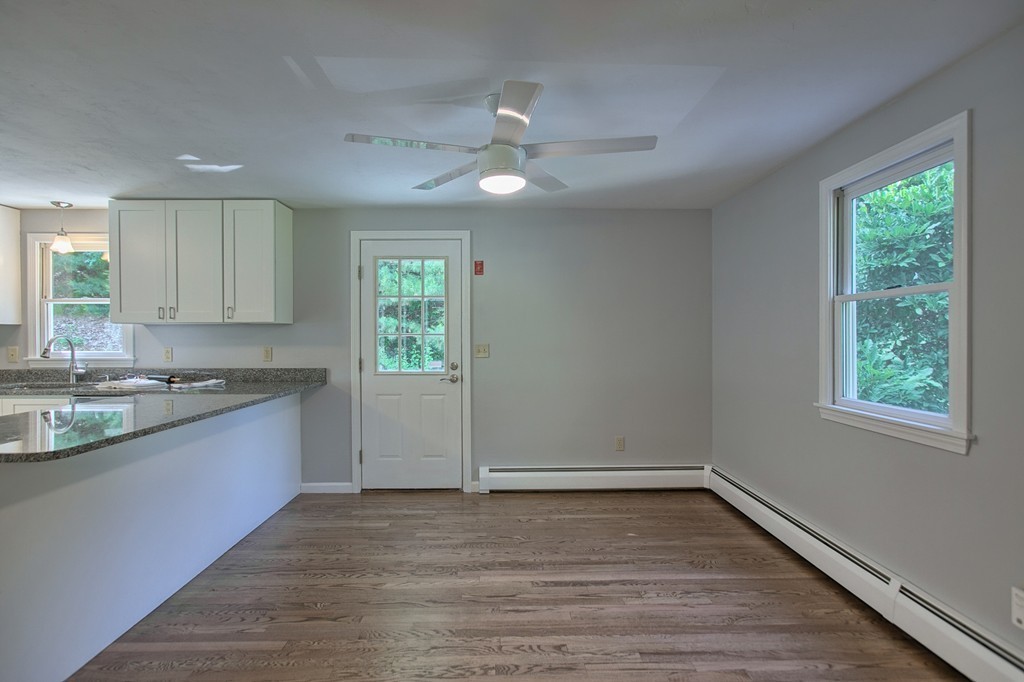 13 Valley Road Groton, MA 01450 - Photo 7 of 30 a large kitchen with wooden floor and stainless steel appliances