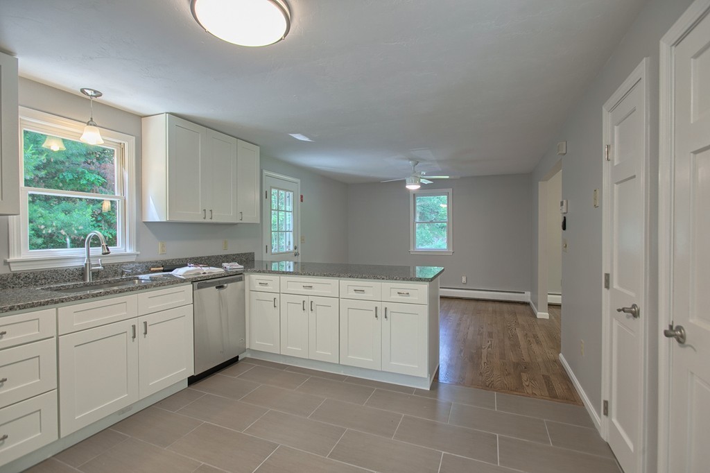 13 Valley Road Groton, MA 01450 - Photo 8 of 30 a spacious bathroom with a granite countertop sink and a mirror