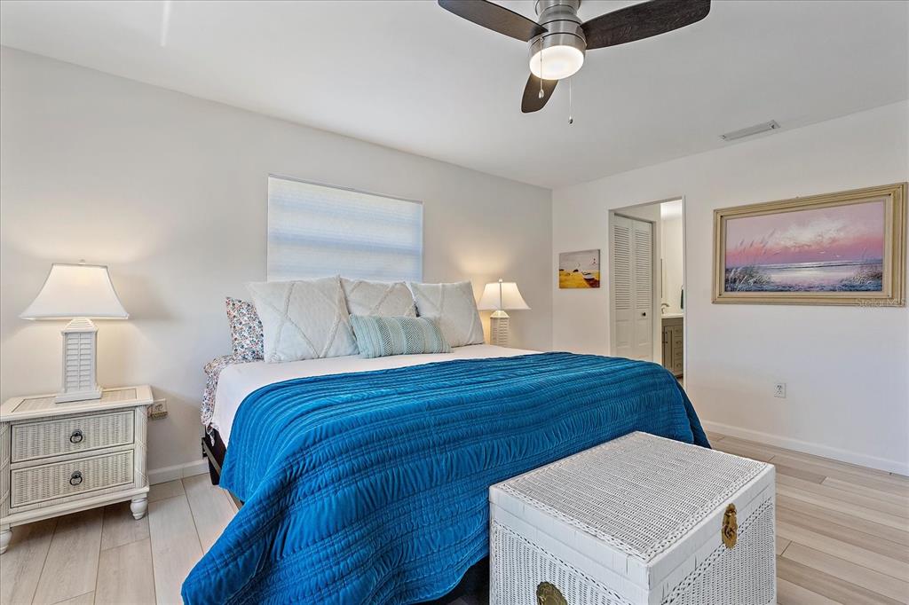 320 Mission Trail North, Unit B Venice, FL 34285 - Photo 12 of 25 a bedroom with a bed and wooden floor