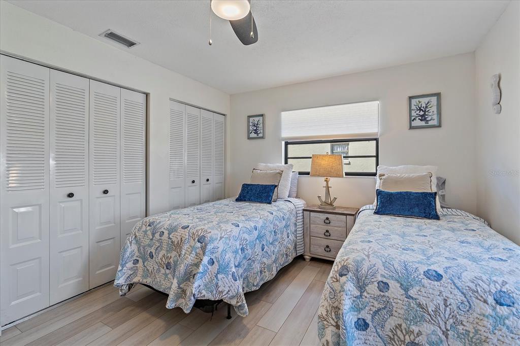 320 Mission Trail North, Unit B Venice, FL 34285 - Photo 16 of 25 a bedroom with two beds and a large window