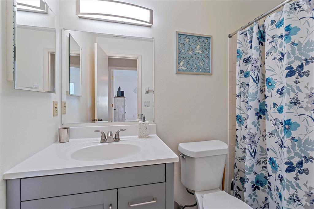 320 Mission Trail North, Unit B Venice, FL 34285 - Photo 18 of 25 a bathroom with a sink toilet and a mirror