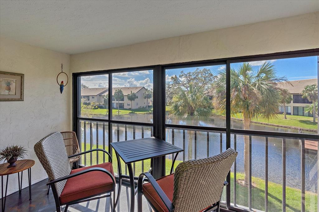 320 Mission Trail North, Unit B Venice, FL 34285 - Photo 20 of 25 a view of a city from a dining room with large windows and wooden floor
