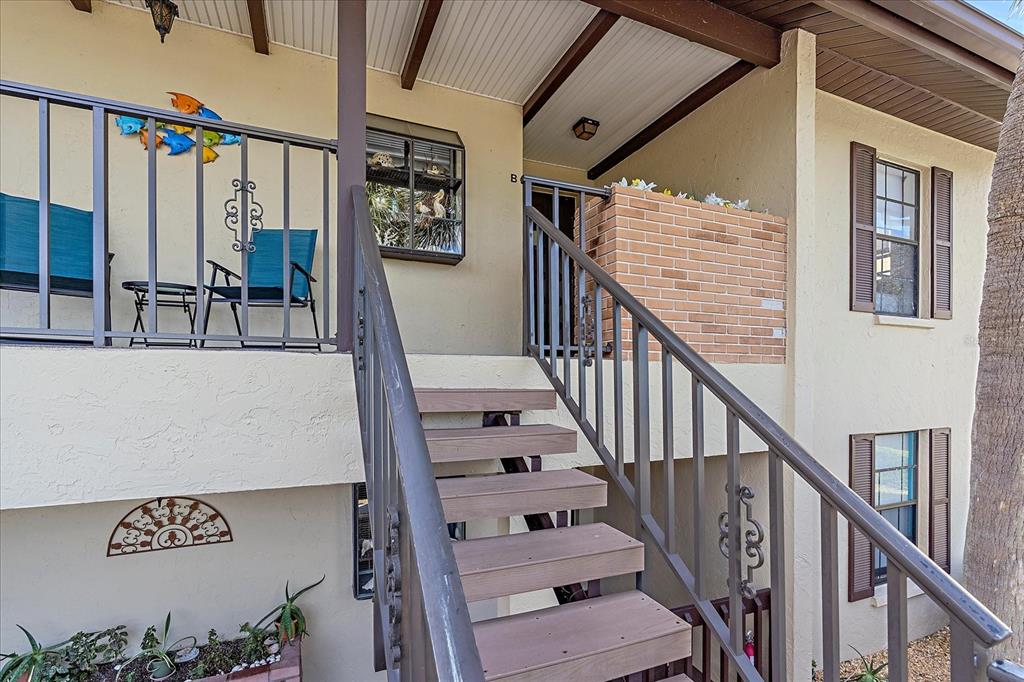 320 Mission Trail North, Unit B Venice, FL 34285 - Photo 24 of 25 a view of staircase with lots of frames on wall and a window