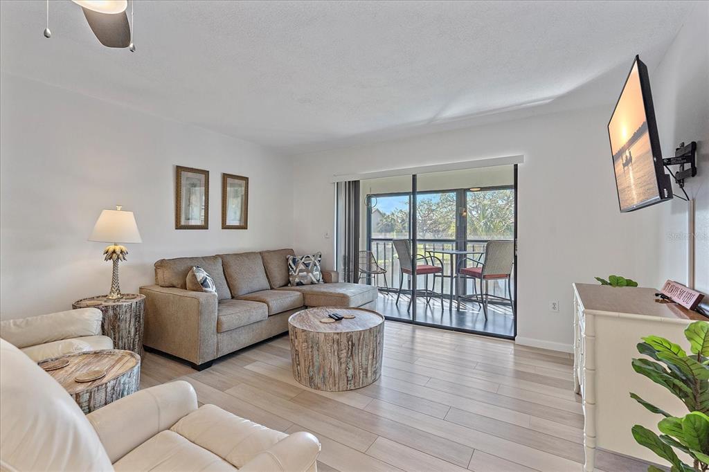 320 Mission Trail North, Unit B Venice, FL 34285 - Photo 4 of 25 a living room with furniture and a large window