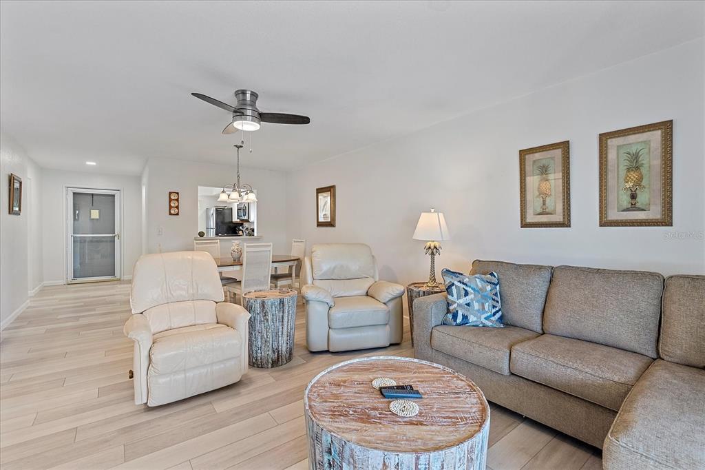 320 Mission Trail North, Unit B Venice, FL 34285 - Photo 5 of 25 a living room with furniture and a fireplace