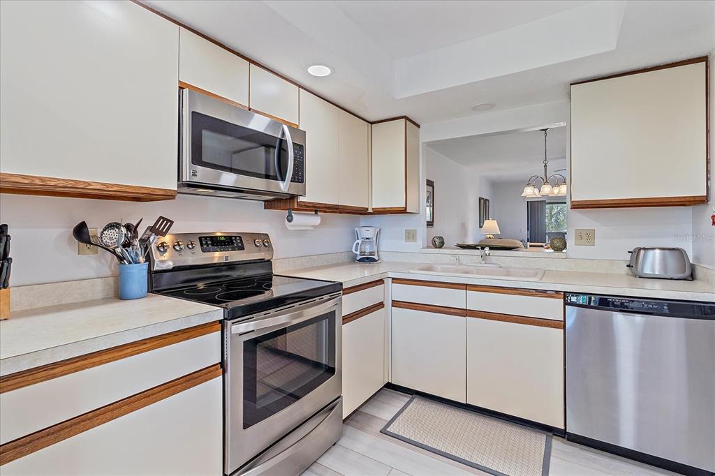 320 Mission Trail North, Unit B Venice, FL 34285 - Photo 9 of 25 a kitchen with cabinets stainless steel appliances and a sink