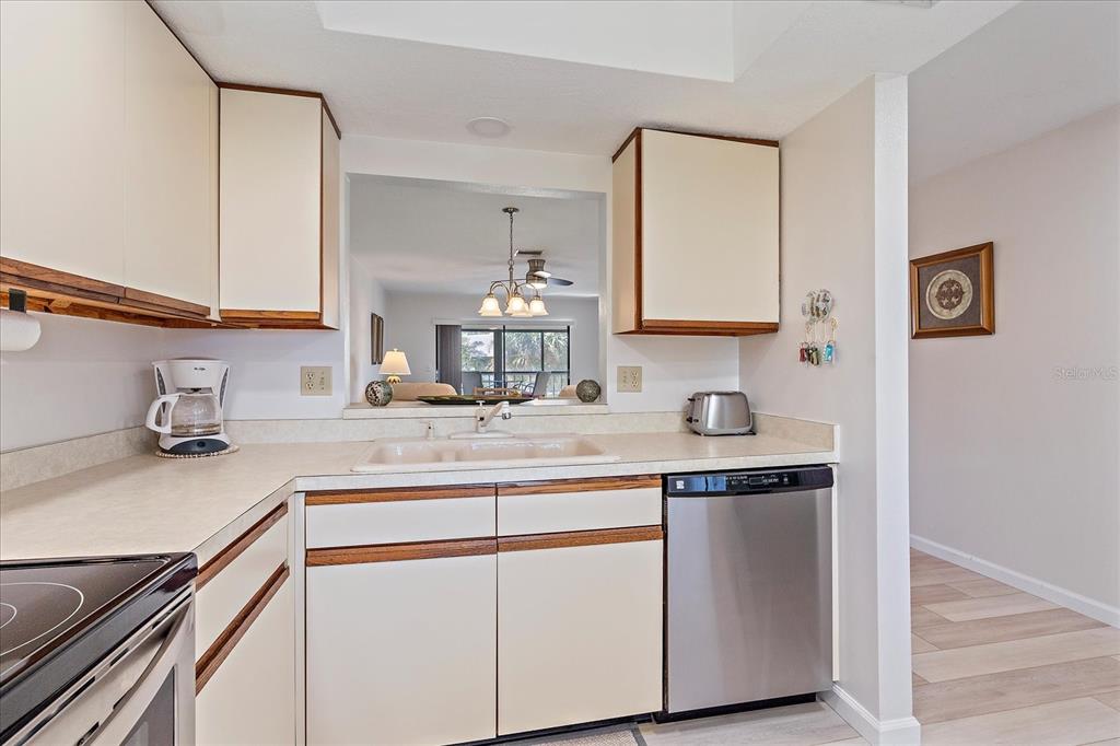 320 Mission Trail North, Unit B Venice, FL 34285 - Photo 10 of 25 a kitchen with stainless steel appliances granite countertop a sink and cabinets