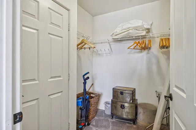 a view of storage and utility room with racks on the wall