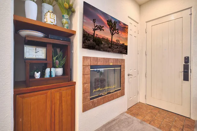 a view of a hallway with a fireplace and cabinets