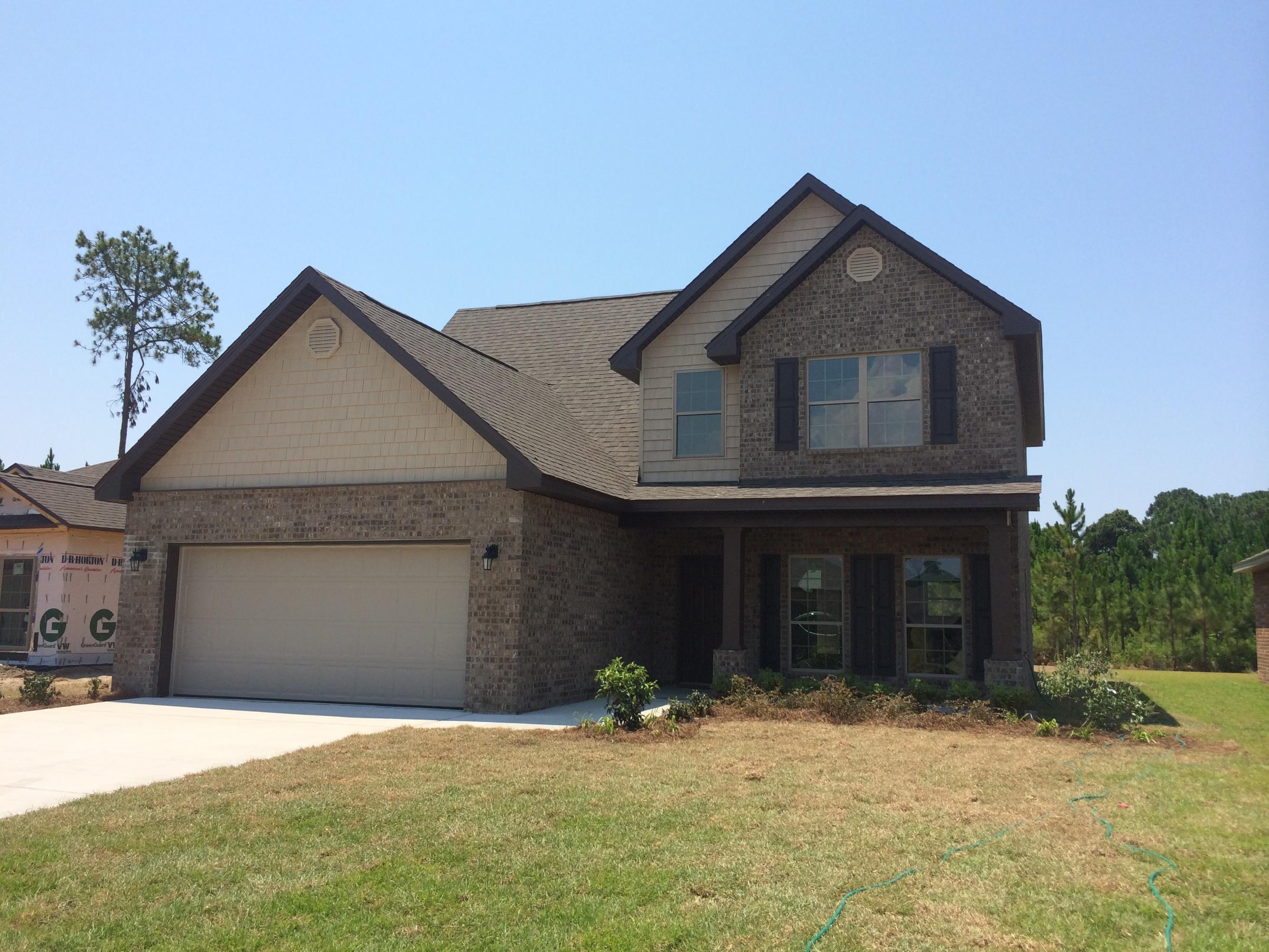 124 Pin Oak Loop Santa Rosa Beach, FL 32459 - Photo 1 of 19 a front view of a house with yard