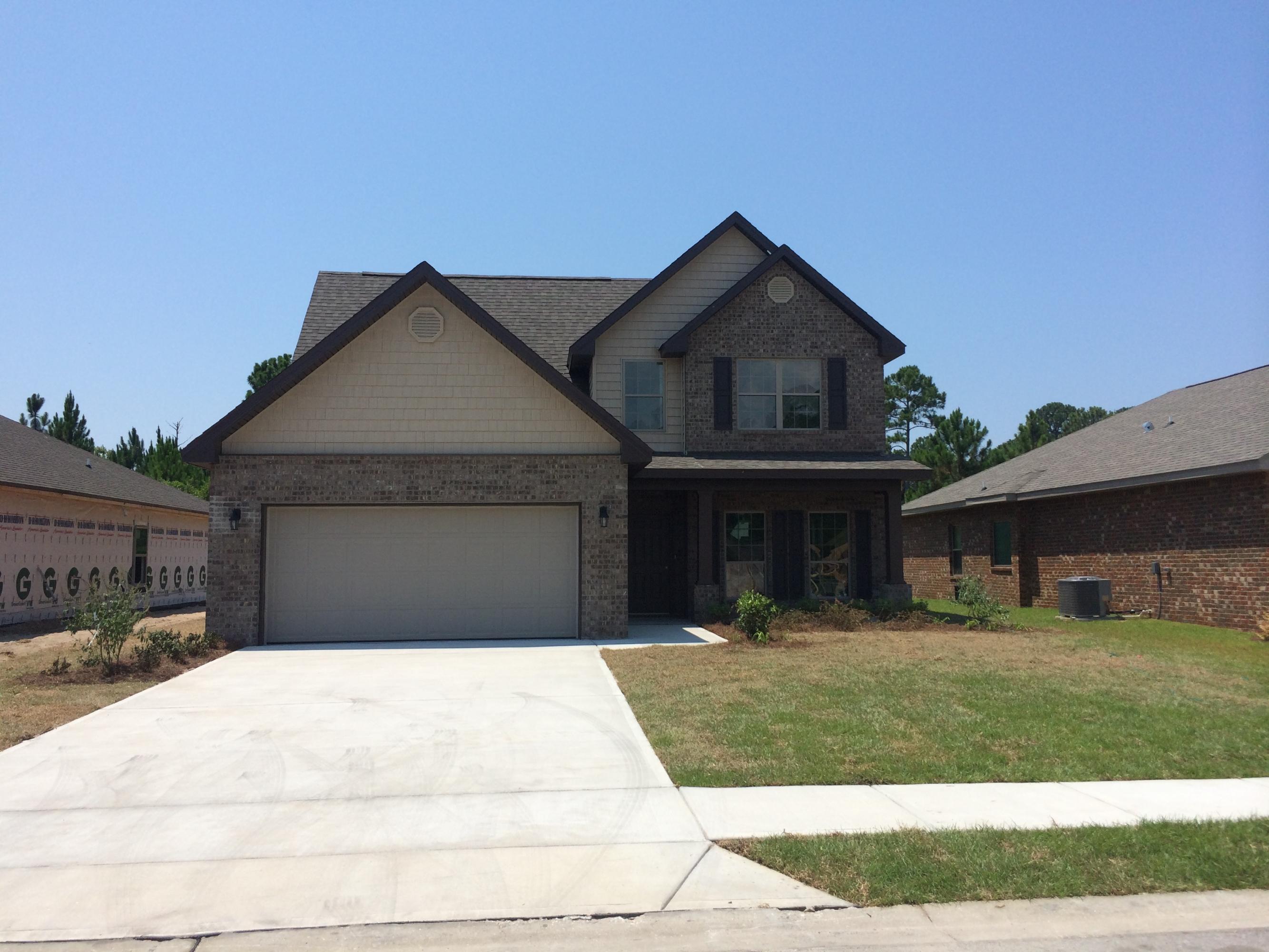 124 Pin Oak Loop Santa Rosa Beach, FL 32459 - Photo 2 of 19 a front view of a house with garage