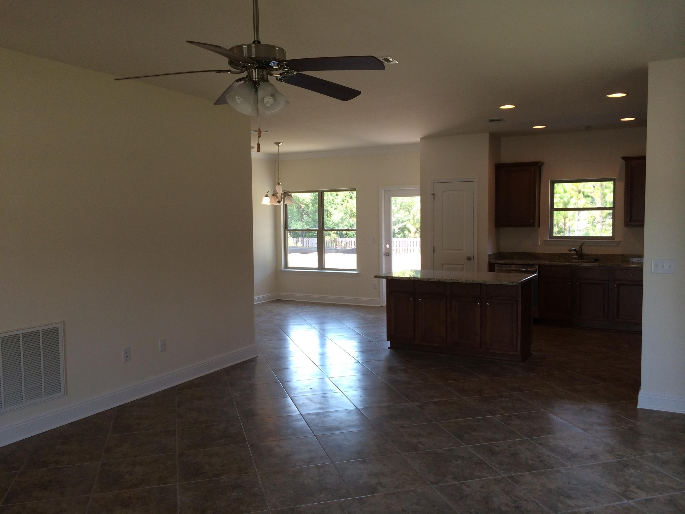 124 Pin Oak Loop Santa Rosa Beach, FL 32459 - Photo 4 of 19 an empty room with wooden floor and windows