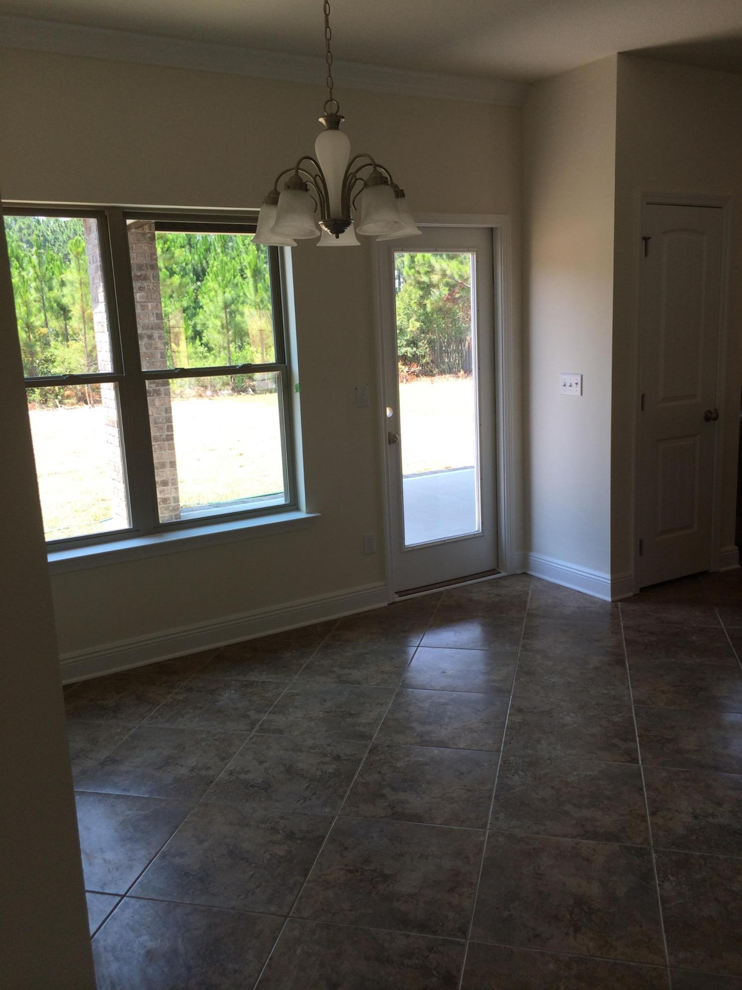 124 Pin Oak Loop Santa Rosa Beach, FL 32459 - Photo 6 of 19 a view of an empty room with a window