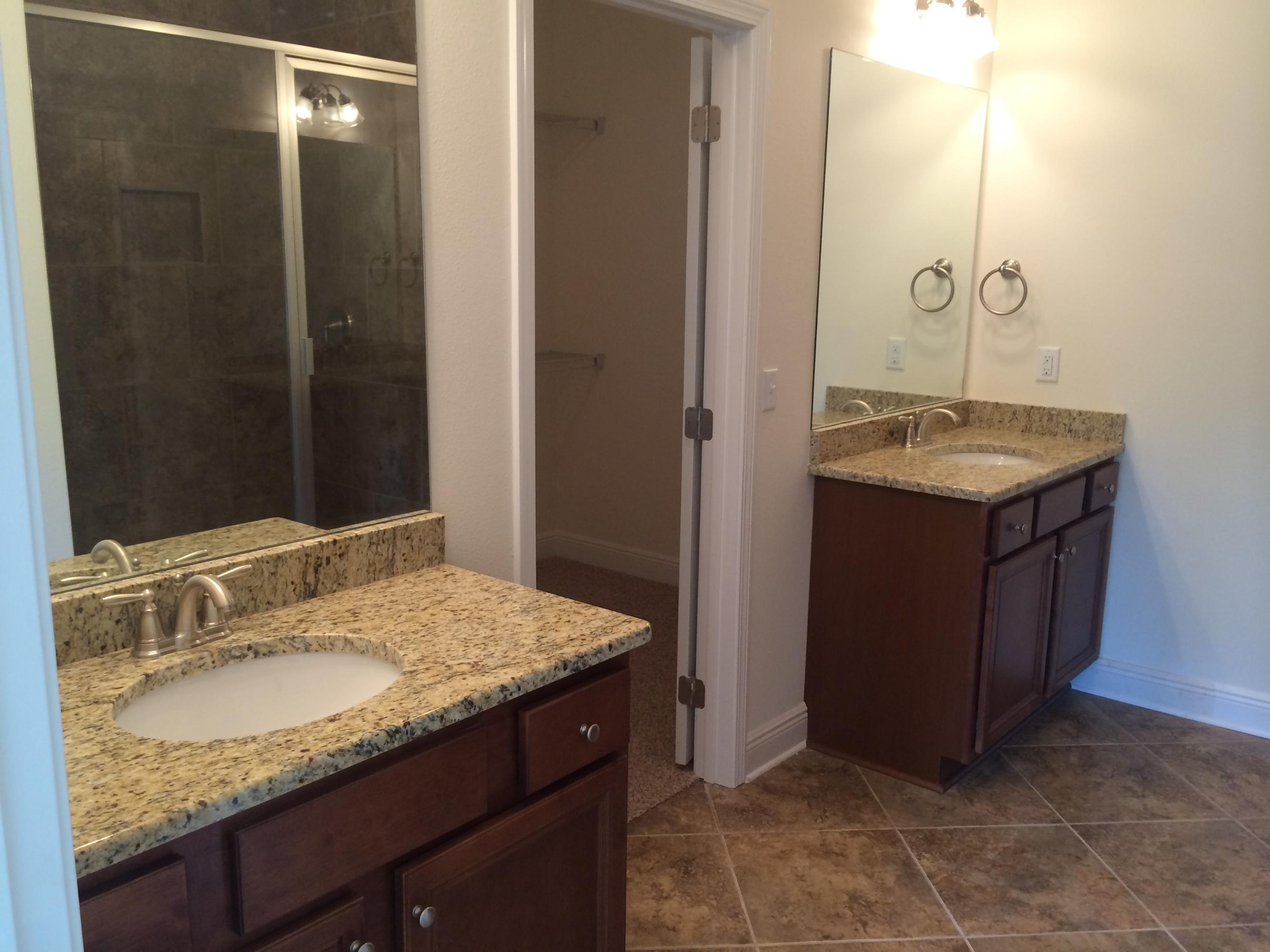 124 Pin Oak Loop Santa Rosa Beach, FL 32459 - Photo 9 of 19 a bathroom with a granite countertop sink and a mirror