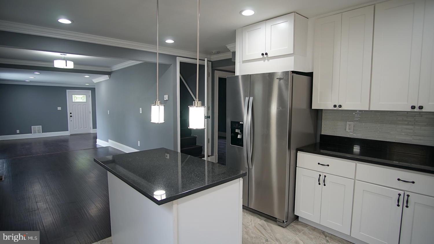 6501 Randolph Road Morningside, MD 20746 - Photo 12 of 35 a kitchen with stainless steel appliances granite countertop a sink a refrigerator and a granite counter tops