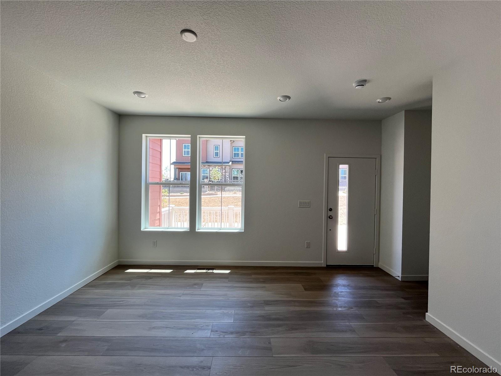 1987 South Gold Bug Way Aurora, CO 80018 - Photo 4 of 18 an empty room with wooden floor and windows
