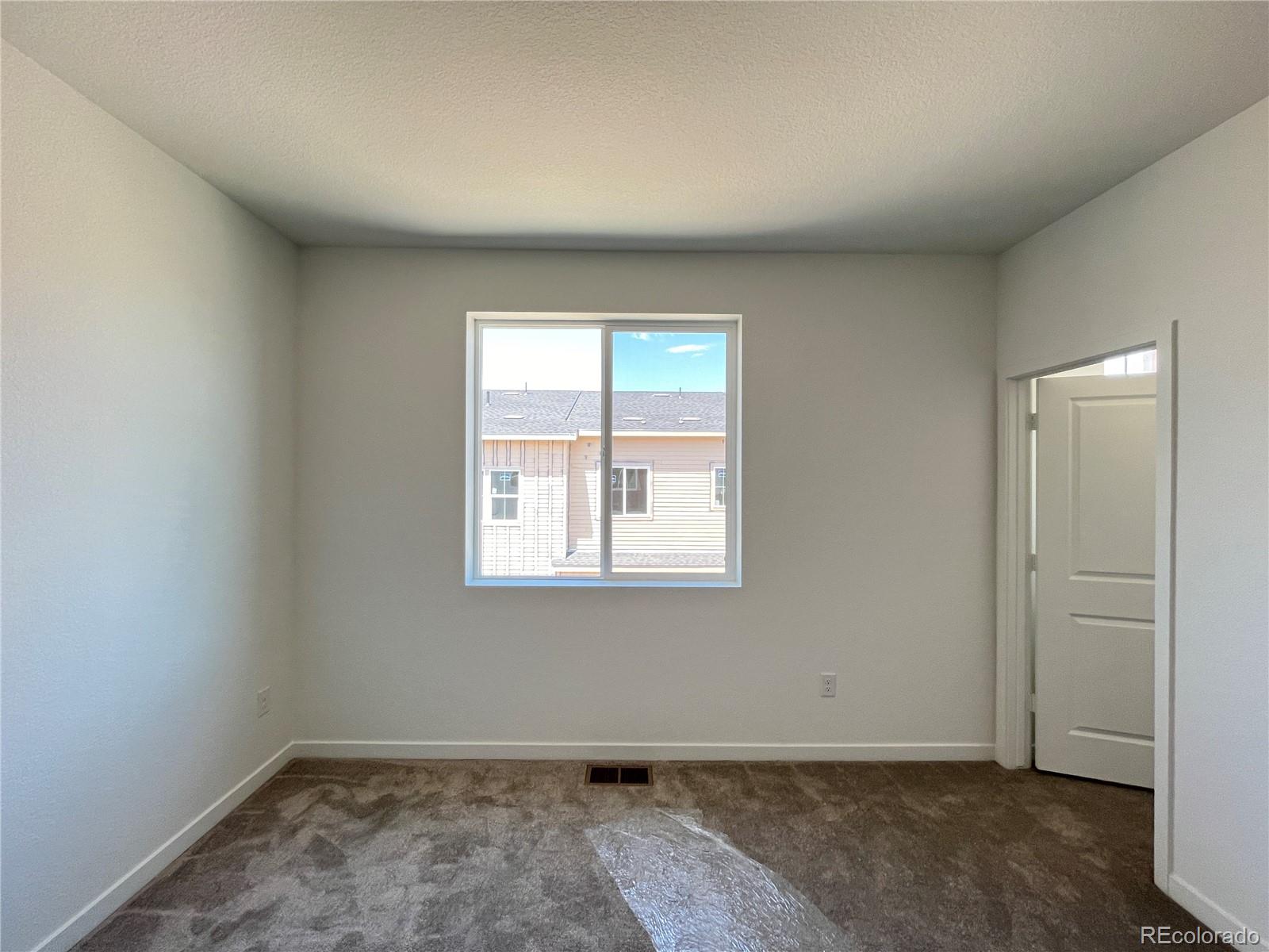 1987 South Gold Bug Way Aurora, CO 80018 - Photo 7 of 18 an empty room with a window