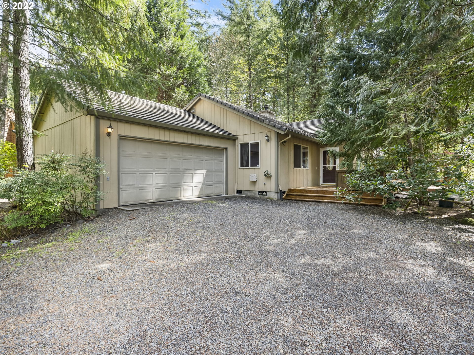 21676 East Lodge Lane Rhododendron, OR 97049 - Photo 1 of 32 a view of a house with a yard and garage