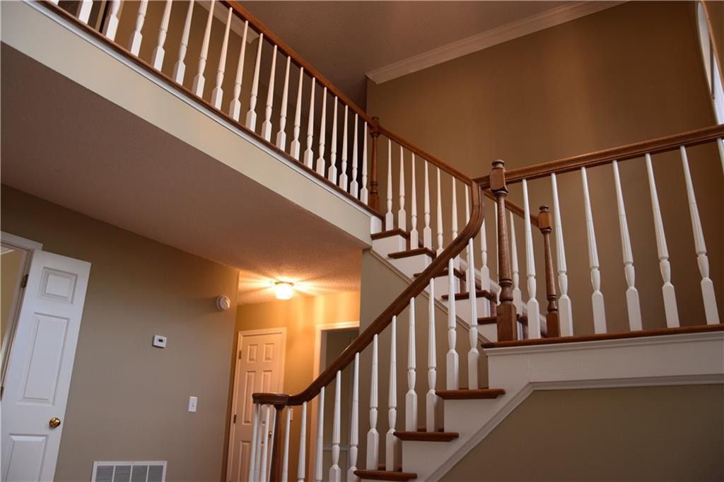 490 Sherman Oaks Way Alpharetta, GA 30004 - Photo 6 of 21 a view of staircase with wooden floor and white walls