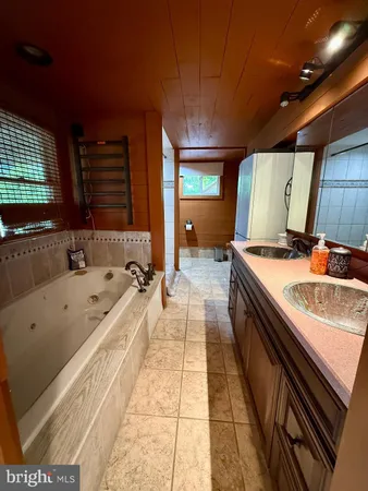 a bathroom with a bathtub and a sink