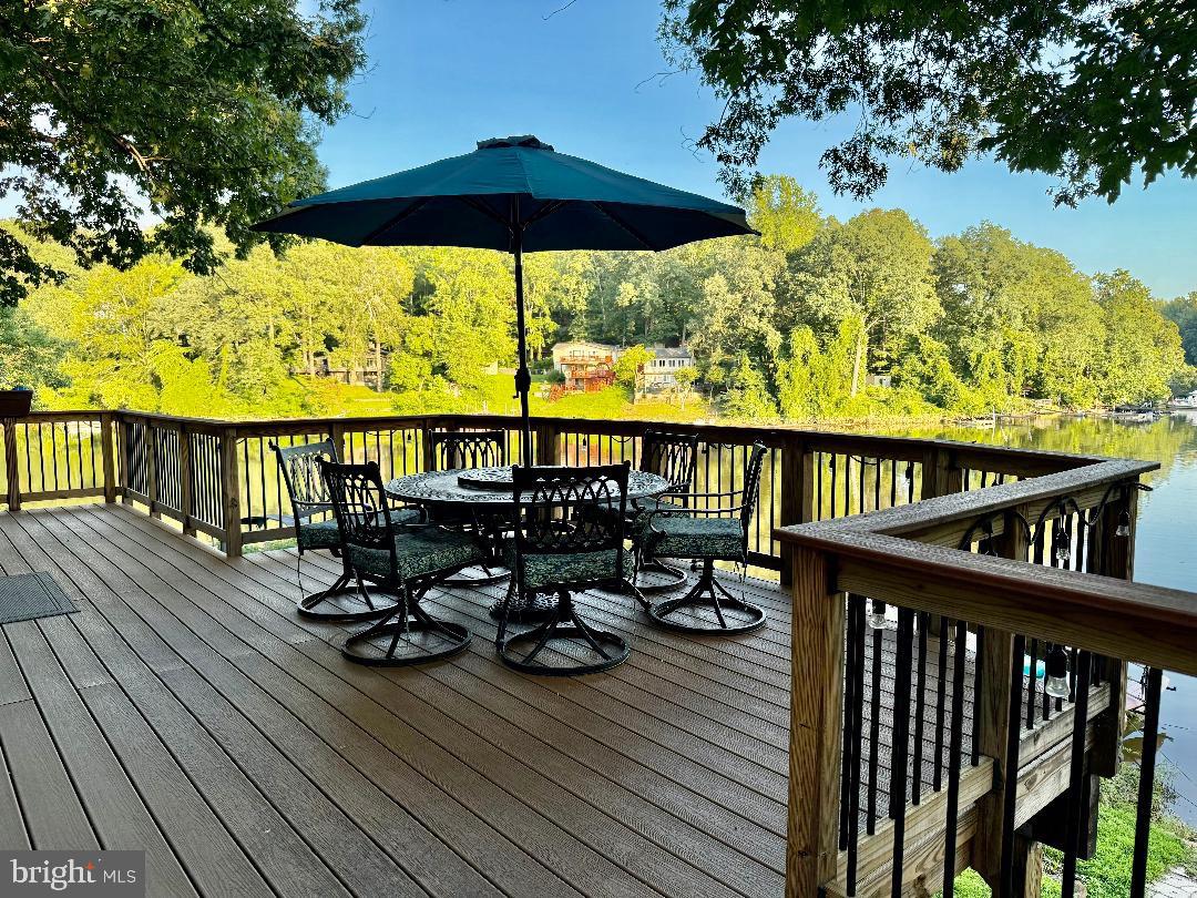 8389 Highview Street Manassas, VA 20112 - Photo 22 of 26 a view of deck with furniture and umbrella