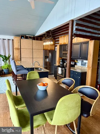 a view of a dining room with furniture and a large window