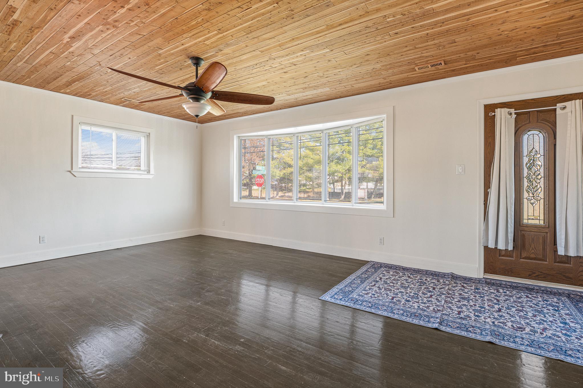 312 North Hammonds Ferry Road Linthicum Heights, MD 21090 - Photo 11 of 56 a view of an empty room with wooden floor and a window