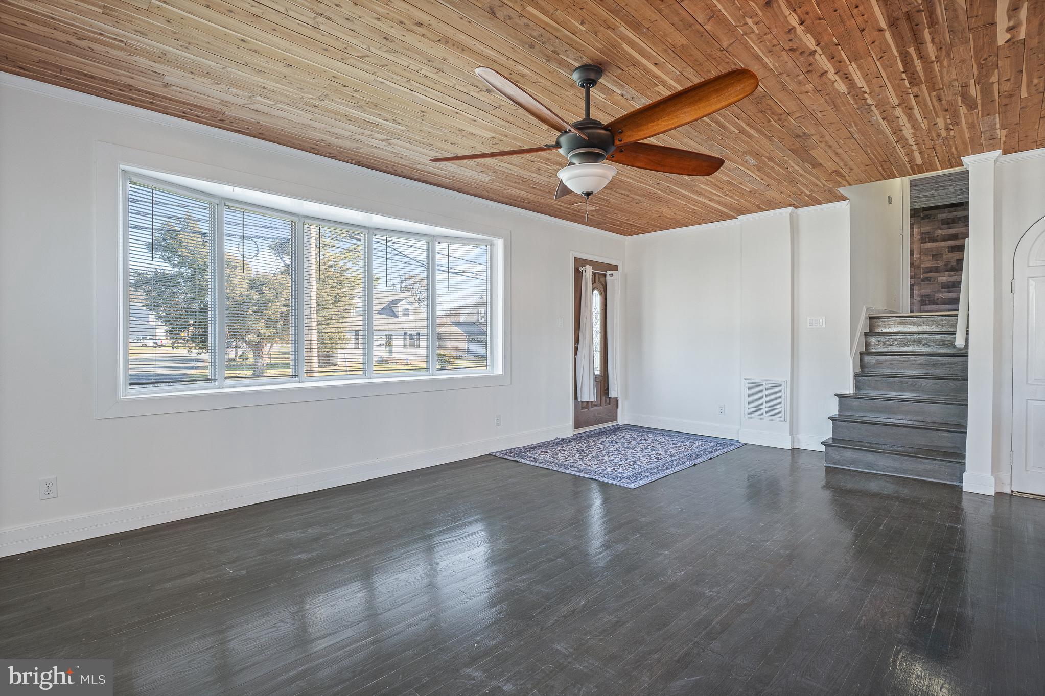 312 North Hammonds Ferry Road Linthicum Heights, MD 21090 - Photo 12 of 56 a view of an empty room with wooden floor and a window