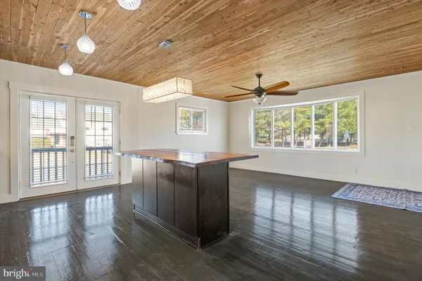 a kitchen with granite countertop wooden cabinets and a wooden floor