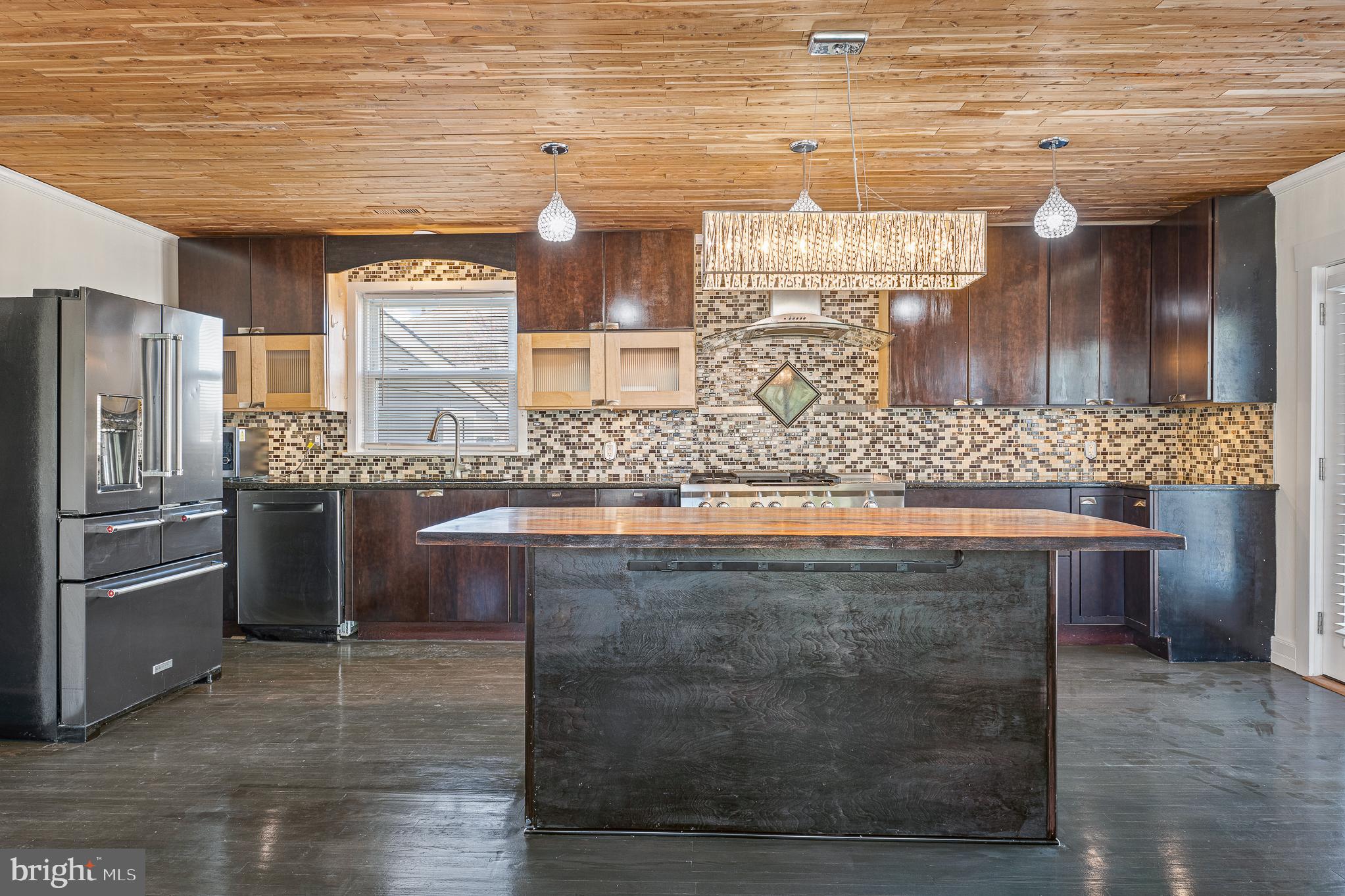 312 North Hammonds Ferry Road Linthicum Heights, MD 21090 - Photo 16 of 56 a kitchen with stainless steel appliances granite countertop a sink and a stove