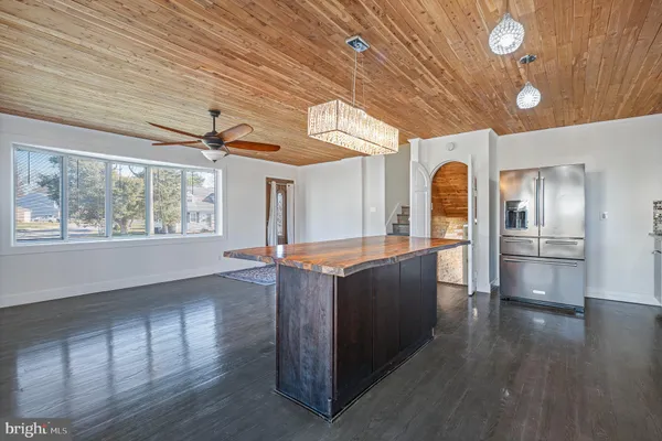 a dining room with wooden floor and a chandelier