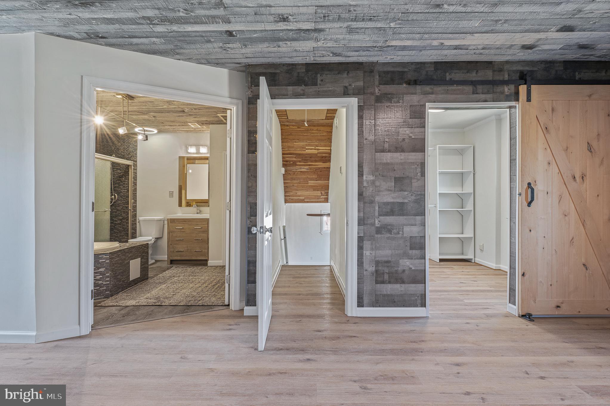 312 North Hammonds Ferry Road Linthicum Heights, MD 21090 - Photo 27 of 56 wooden floor and a bathroom with a glass door shower