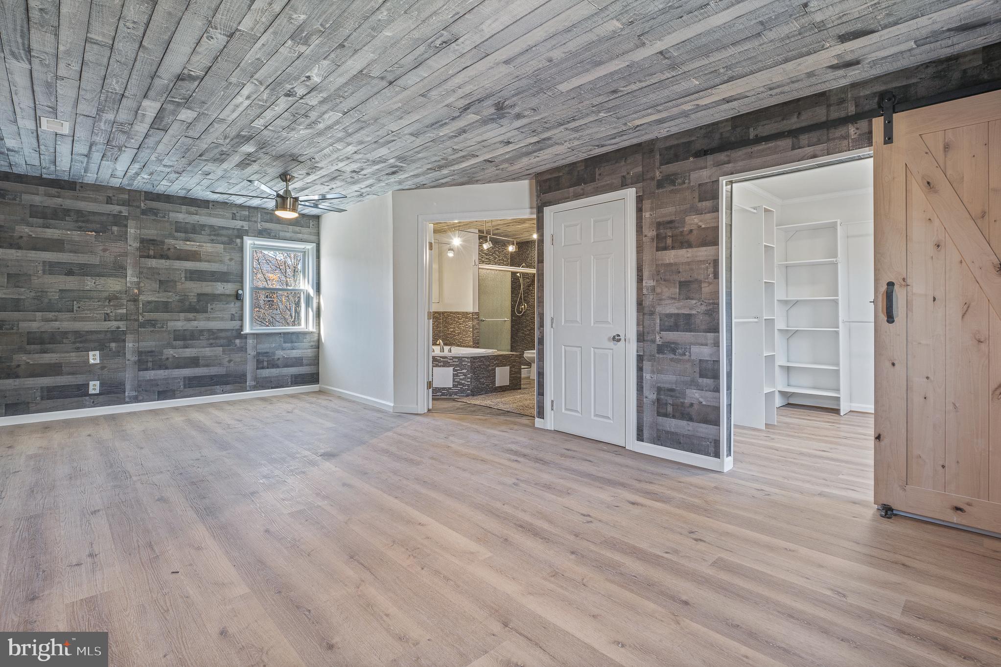 312 North Hammonds Ferry Road Linthicum Heights, MD 21090 - Photo 28 of 56 wooden floor in an empty room with a fireplace