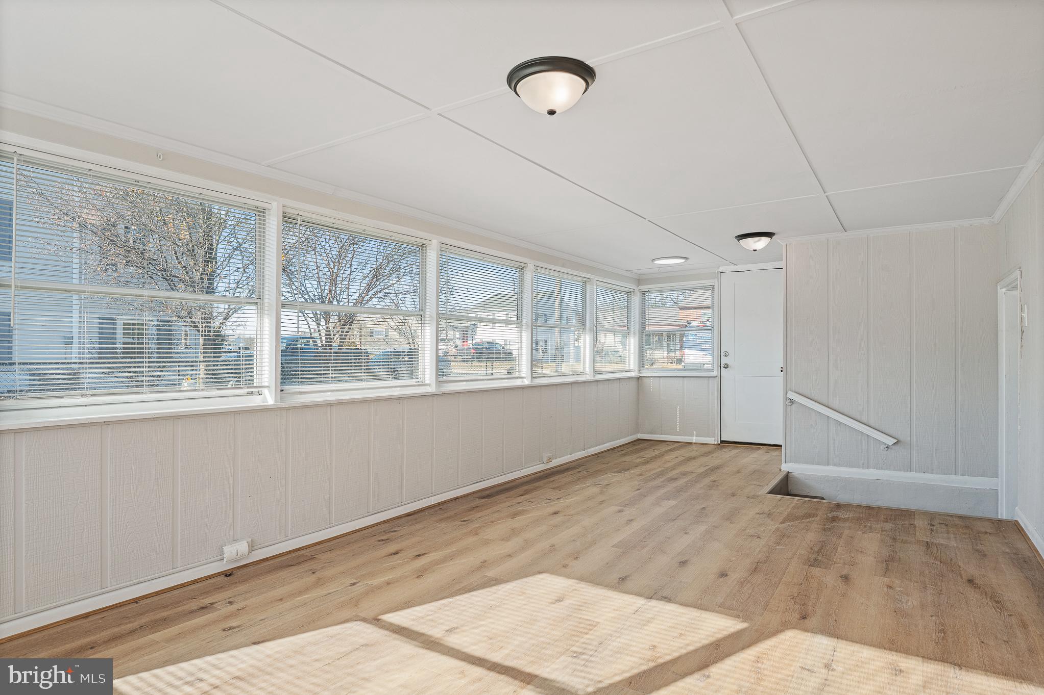 312 North Hammonds Ferry Road Linthicum Heights, MD 21090 - Photo 41 of 56 an empty room with wooden floor and windows