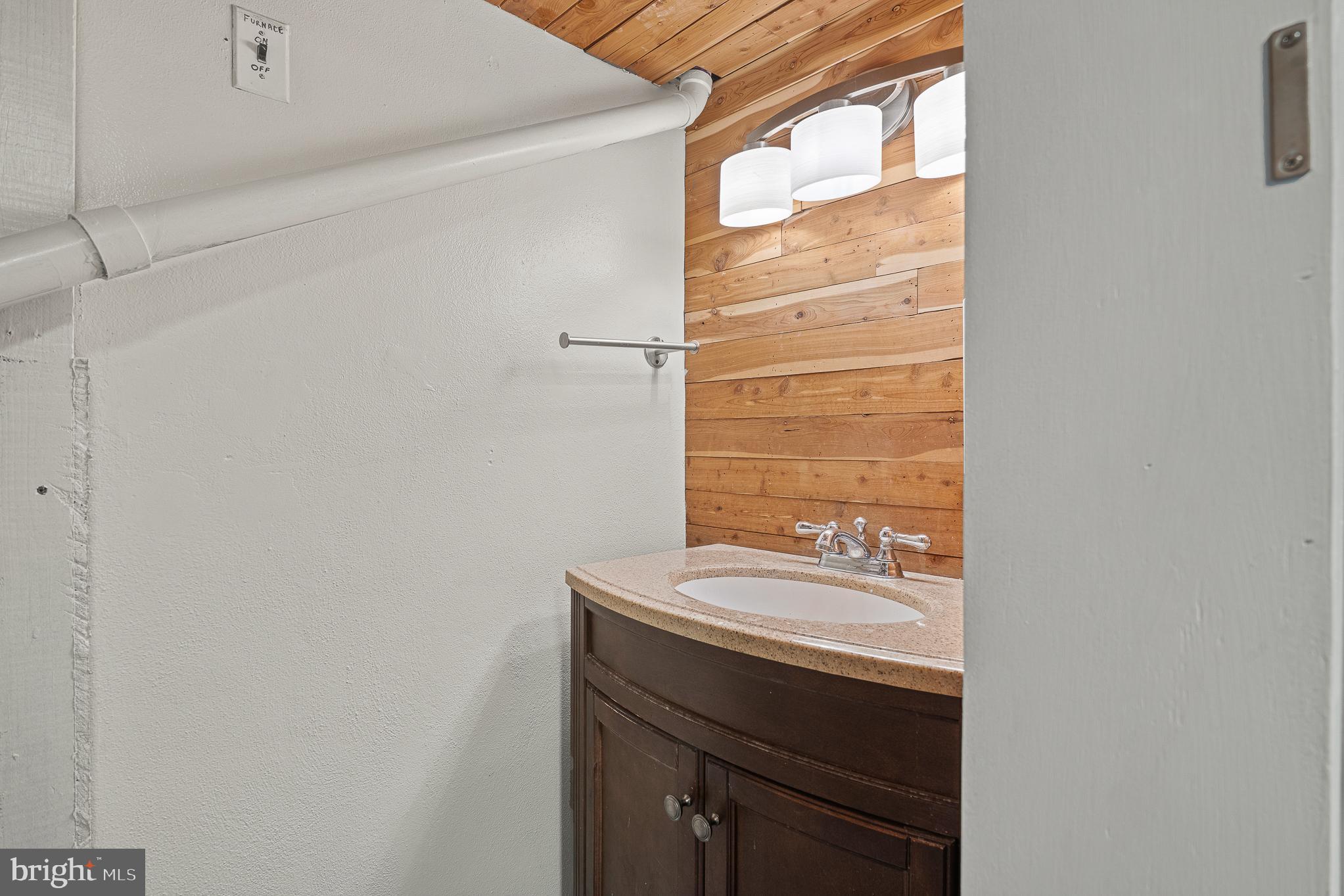 312 North Hammonds Ferry Road Linthicum Heights, MD 21090 - Photo 45 of 56 a bathroom with a sink a vanity and a bathtub