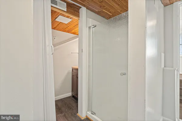 a view of an empty room with wooden floor