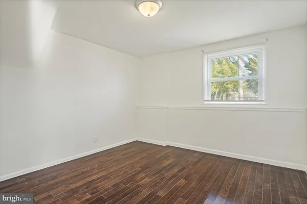 an empty room with wooden floor