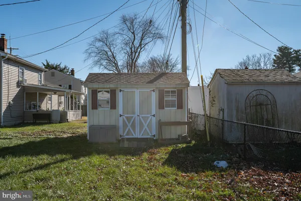 a view of a house with a big yard and a large tree
